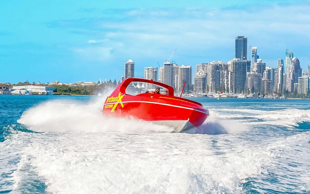 Boat on the water. City skyline.