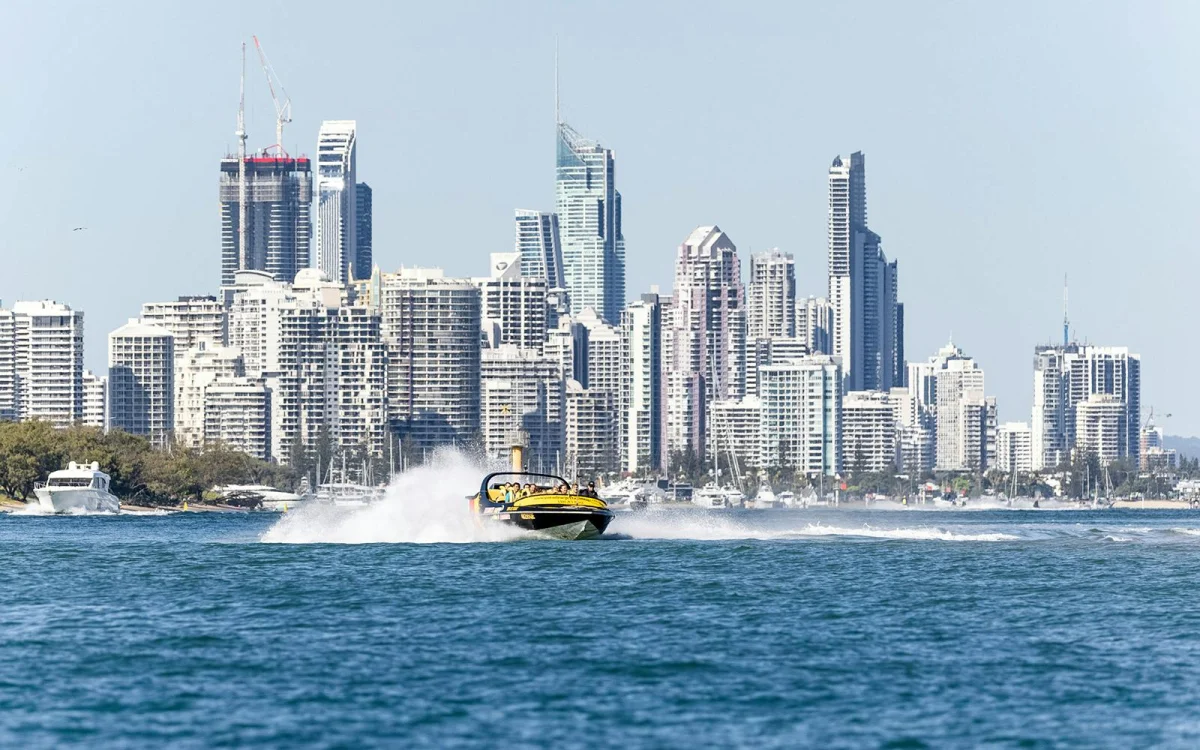 Boat on the water. City skyline.