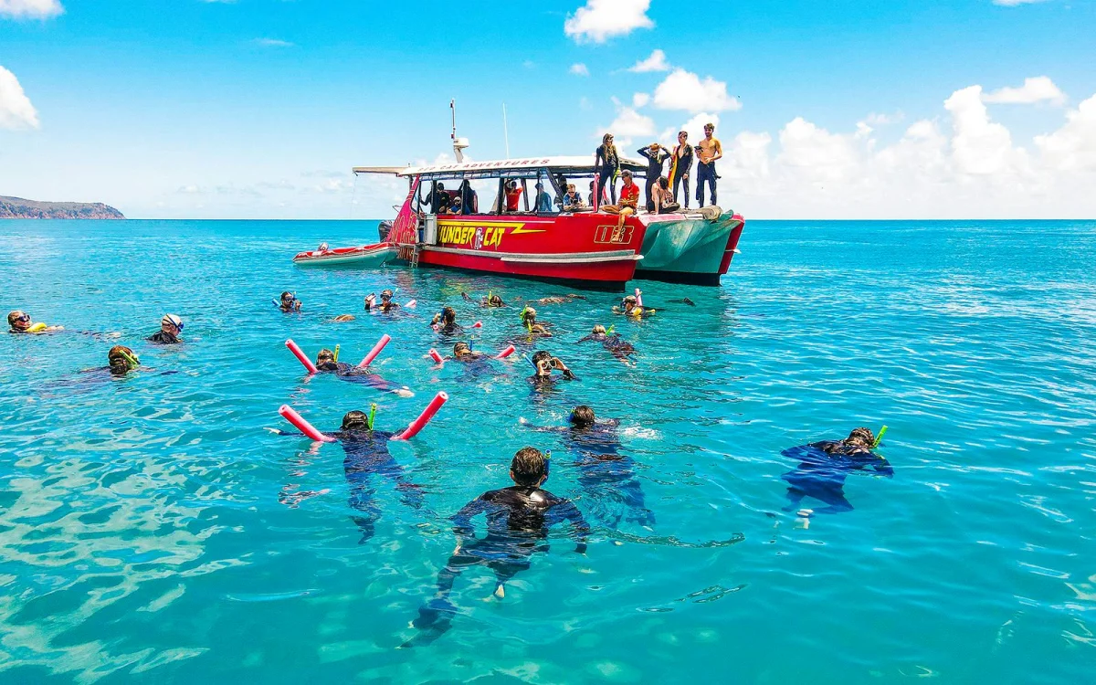 Snorkelling in the water. Boat on the water.