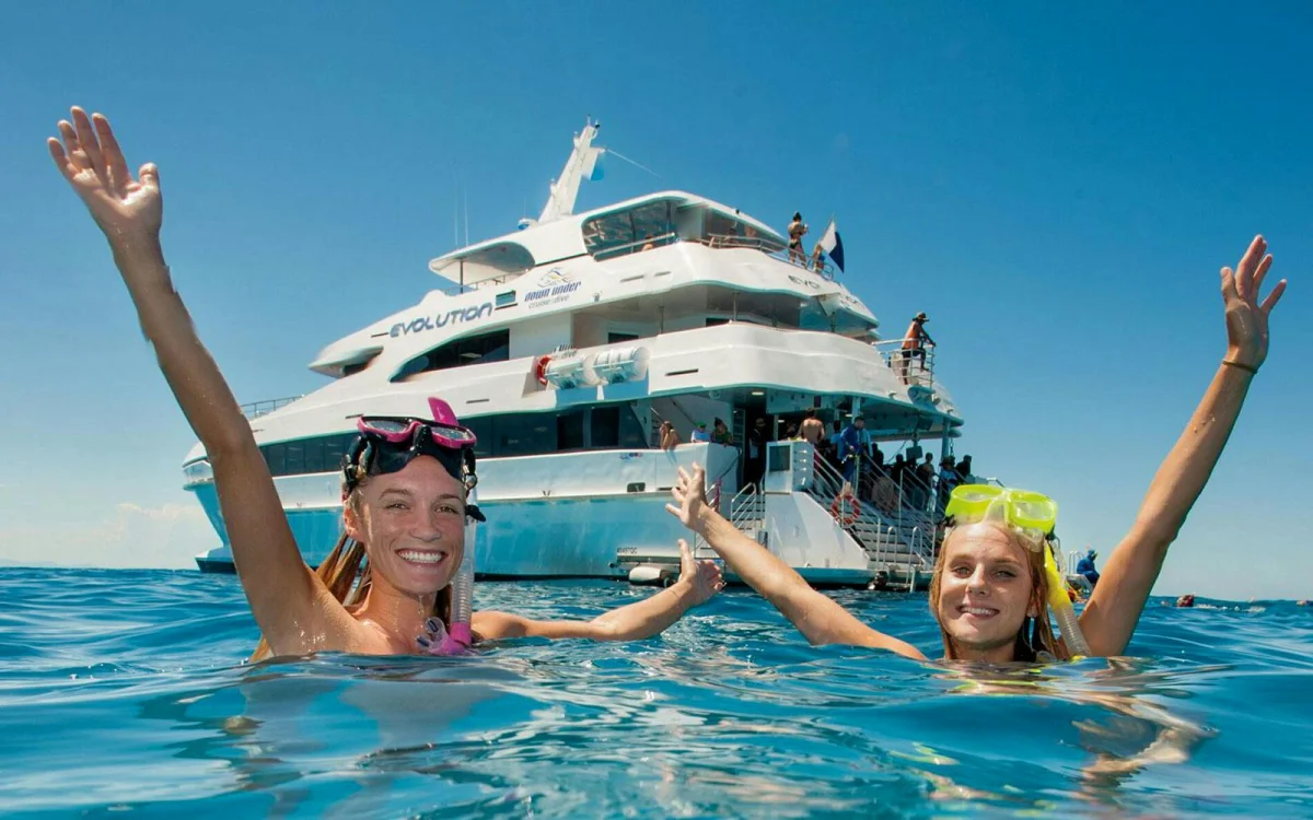 Snorkelling in the water. Boat on the water.